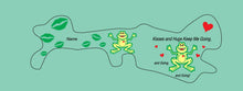 Load image into Gallery viewer, Doc Band Wrap printed with frogs and the words kisses and hugs keep me going, and going,and going. background color is light green. 
